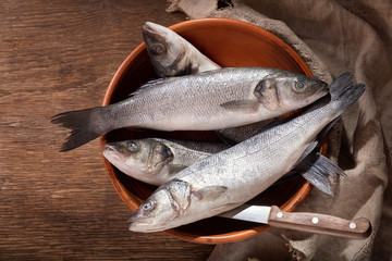 Canvas Print - fresh fish are ready for cooking on a wooden table