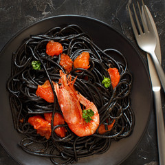 Wall Mural - Squid ink pasta with prawns and tomatoes