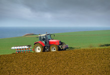 Farmer Plowing His Fields In Autumn