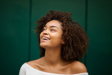 close up young african american woman smiling and looking up