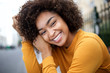 © mimagephotos - Close up young african american woman smiling with curly hair