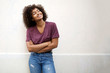© mimagephotos - cool african american girl smiling with arms crossed by white background