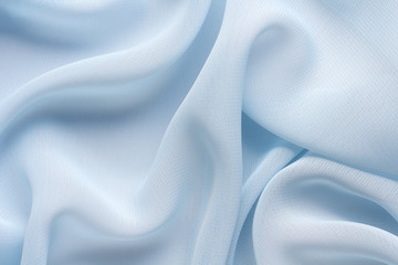 Wall Mural - delicate blue fabric with large folds, textile background