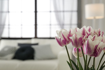 Wall Mural - Blurred view of modern room interior, focus on fresh flowers