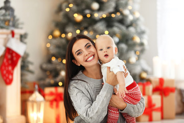 Poster - Mother with her cute baby at home. Christmas celebration