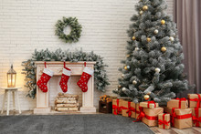 Stylish Christmas Interior With Decorated Fir Tree And Fireplace