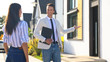 © New Africa - Real estate agent showing house to young woman outdoors