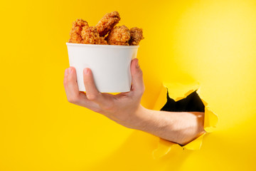 Hand giving chicken nuggets