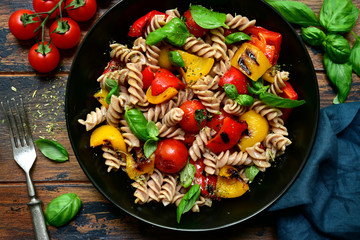 Canvas Print - Whole wheat fusilli pasta with grilled vegetables. Top view with copy space.