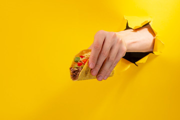 Hand holding a taco