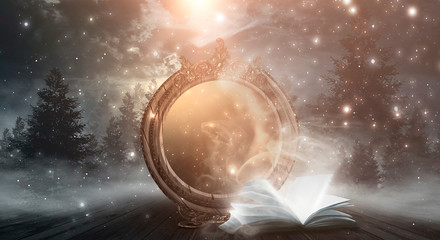Wall Mural - an open book and a magic mirror against the backdrop of a night landscape. abstract dark scene, myst