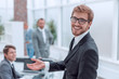 © ASDF - close up. smiling friendly businessman standing in the office