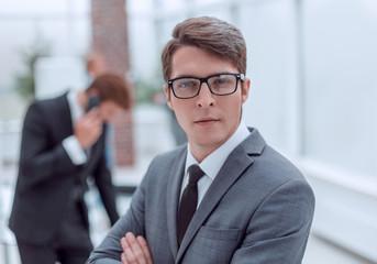 Wall Mural - successful business man standing in a modern office.