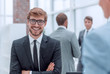 © ASDF - smiling young businessman at the workplace office.