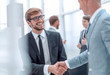 © ASDF - smiling businessman shaking hands with his business partner