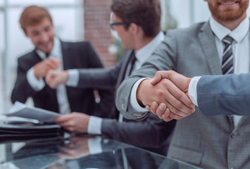 business people shaking hands during a business meeting .