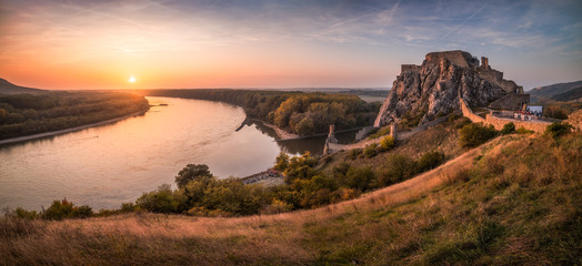 Wall Mural - Famous Devin Castle Ruin Located at Confluence of Danube River and Morava River near Bratislava, Slovakia at Sunset