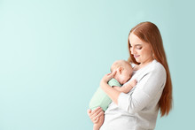 Mother With Cute Baby On Color Background