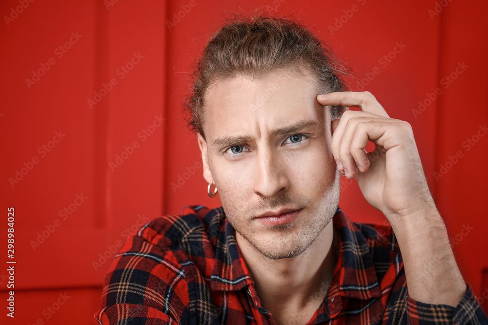 Portrait of handsome young man on color background