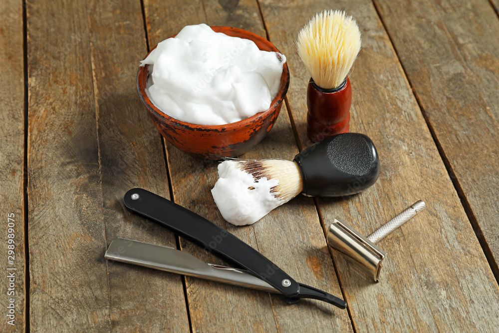Set for male shaving on wooden background