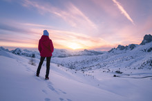 Young Woman In Snowy Mountains At Sunset In Winter. Landscape With Beautiful Slim Girl On The Hill Against Snow Covered Rocks And Colorful Sky With Clouds In The Evening. Travel In Dolomites. Tourism.