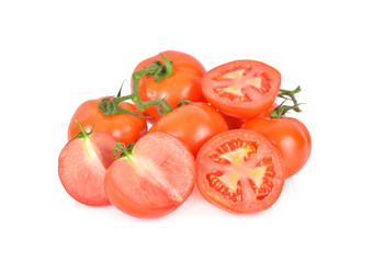 whole and cut tomatoes with stem on white background