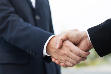 Wall Mural - Closeup of a businessman hand shake investor between two colleagues  OK, succeed in business Holding hands.