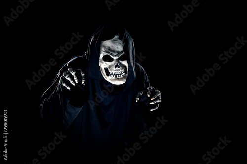Fotomural Scary monster or grim reaper ghost coming out of the dark shadows to haunt during Halloween