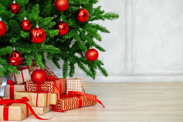 Stack of wrapped presents under Christmas tree
