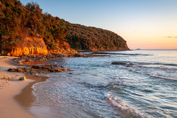 Scenic rocky beach Cala Violina landscape at the sunset. Tyrrhenian Sea bay at the sunset