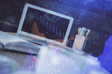 Stock market chart hologram drawn on personal computer background. Multi exposure. Concept of investment.