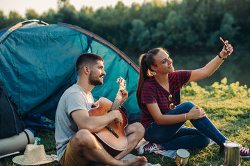 Wall Mural - romantic couple on camping by the river outdoors