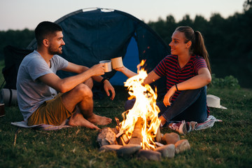 Wall Mural - romantic couple on camping by the river outdoors