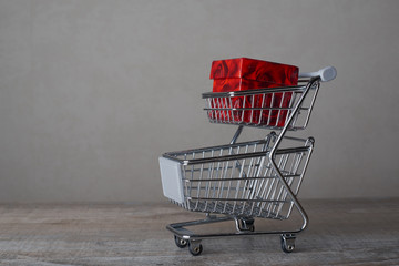 Shopping cart and box on wood table with white background business shopping , concept online shopping.