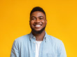 Portrait of cheerful bearded black man over yellow background