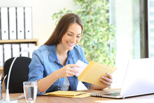 Happy Entrepreneur Putting Document In An Envelope