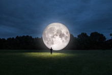Man Standing In Front Of The Moon. Elements Of This Image Furnished By NASA.