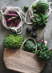 Wall Mural - Flat-lay of of grocery jute and net bags with organic vegetables, greens, fruit from local farmers market over concrete background. Zero waste, healthy, eco-friendly, vegan and clean eating concept