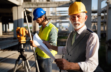 Engineer, contractor, architect teamwork. Construction people talking and planning work, blueprint