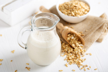 Poster - Oat milk. Healthy vegan non-dairy organic drink with flakes