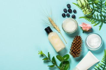 Wall Mural - facial cosmetics, skin care product on blue.