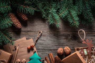 Wall Mural - Christmas green frame from fir branches on a vintage gray board background. Frame of fir branches. Christmas card blank.
