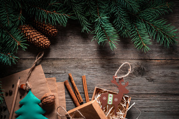 Wall Mural - Christmas green frame from fir branches on a vintage gray board background. Frame of fir branches. Christmas card blank.