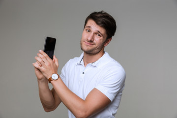 Sticker - Confused young man talking by mobile phone