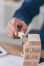 Cropped View Of Businessman Putting Wooden Block On Stack