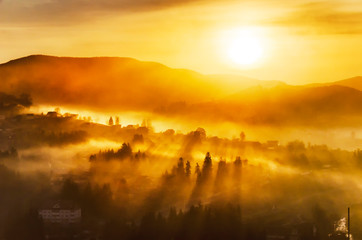 Canvas Print - Bright misty sunrise in a mountain village