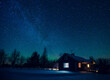 © nblxer - Cottage against the night sky with the Milky Way and the arctic Northern lights Aurora Borealis in snow winter Finland