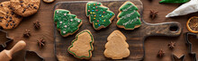 Top View Of Glazed Christmas Cookies With Pastry Bag On Wooden Cutting Board, Panoramic Shot