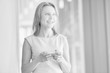 © MDBPIXS - Black and white photo of mature businesswoman using smartphone in office