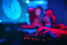 Blurred Background Computer, Keyboard, Blue And Red Lights. Concept ESports Arena For Gamer Playing Tournaments